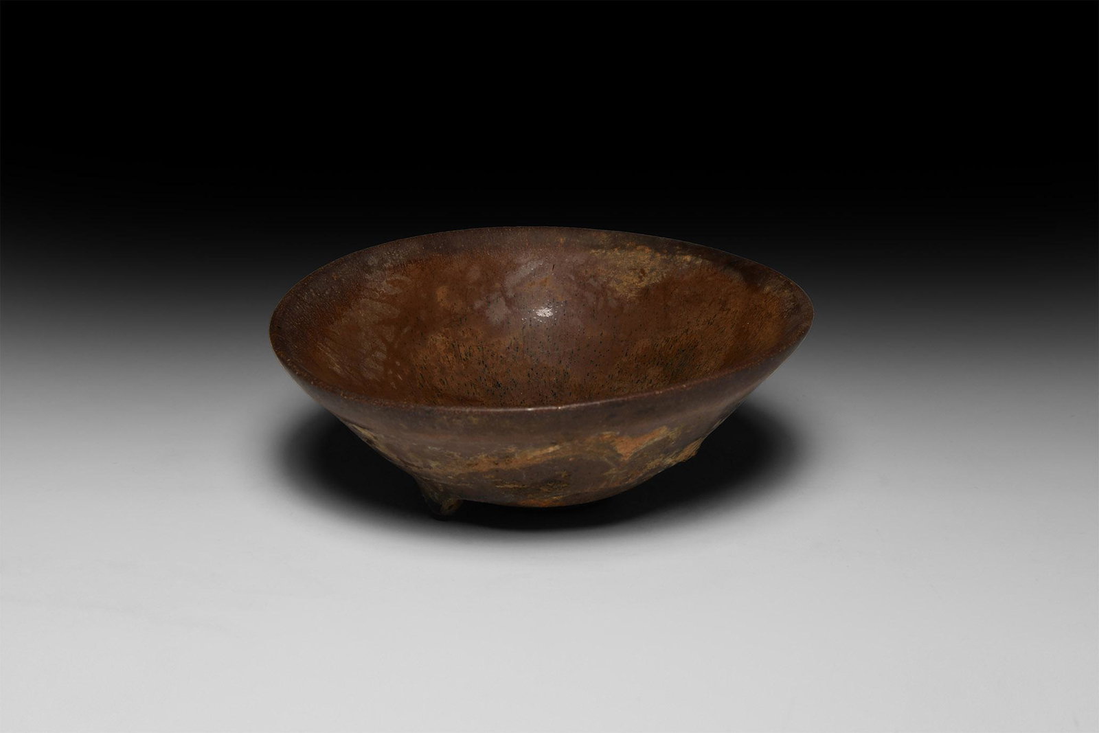 Chinese Song Hare's Fur Tea Bowl: Song Dynasty, 960-1127 AD. A conical ceramic bowl with basal ring, covered in a mottled dark glaze, the inside streaked with fine russet-coloured 'hare’s fur' markings. See Lili, F., Chinese Ceramic