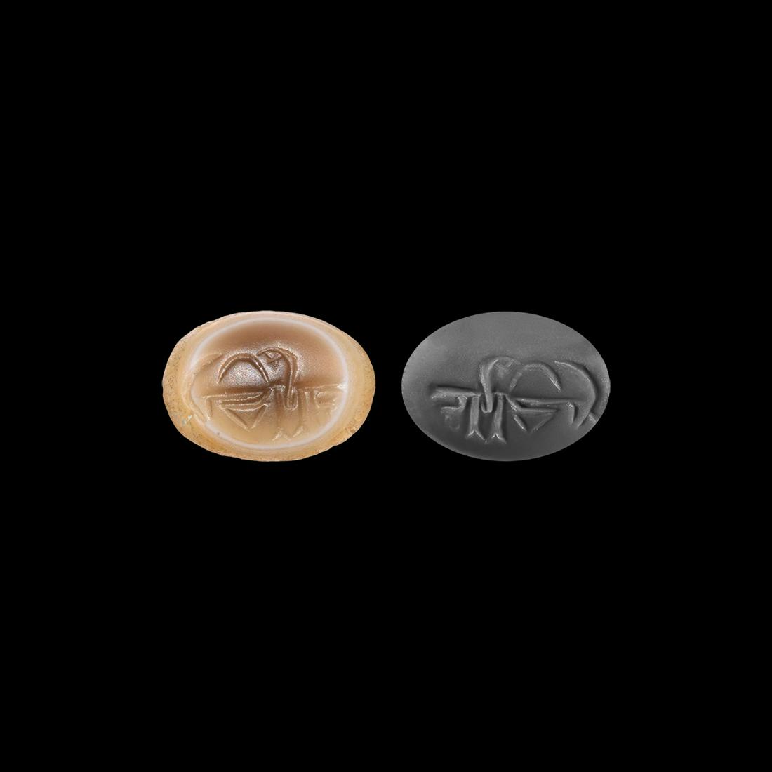 Burmese Inscribed Gemstone Intaglio: 14th-15th century AD. An agate oval intaglio engraved with Burmese script; accompanied by a museum-quality impression. 1.51 grams, 16mm (1/2"). Property of a London gentleman; acquired by his father i