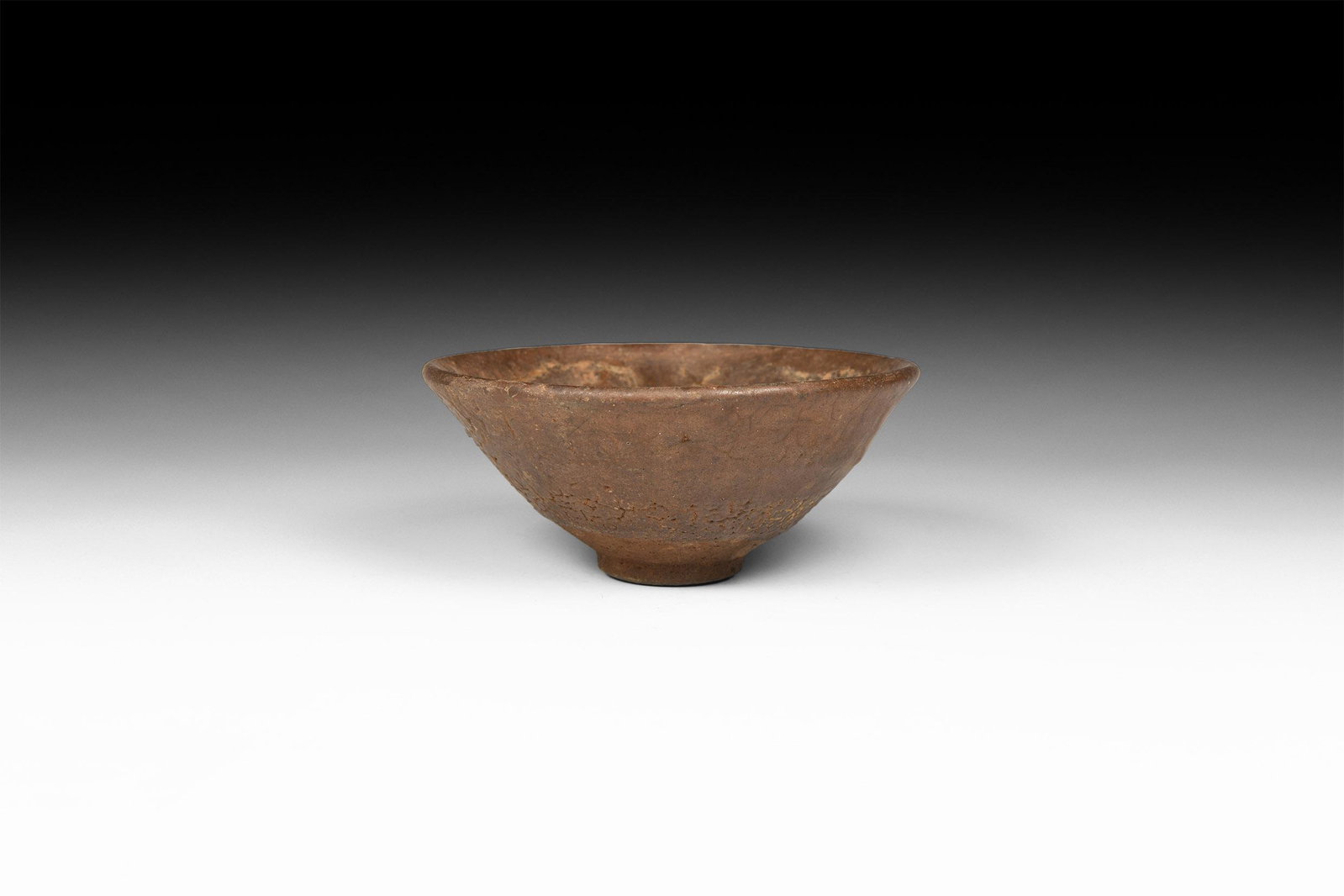 Chinese Song Jianyao 'Hare's Fur' Tea Bowl: Song Dynasty, 960-1127 AD. A conical ceramic bowl covered in a mottled dark glaze once streaked with fine russet-coloured 'hare’s fur' markings See Lili, F., Chinese Ceramics, Cambridge, 2011, for d