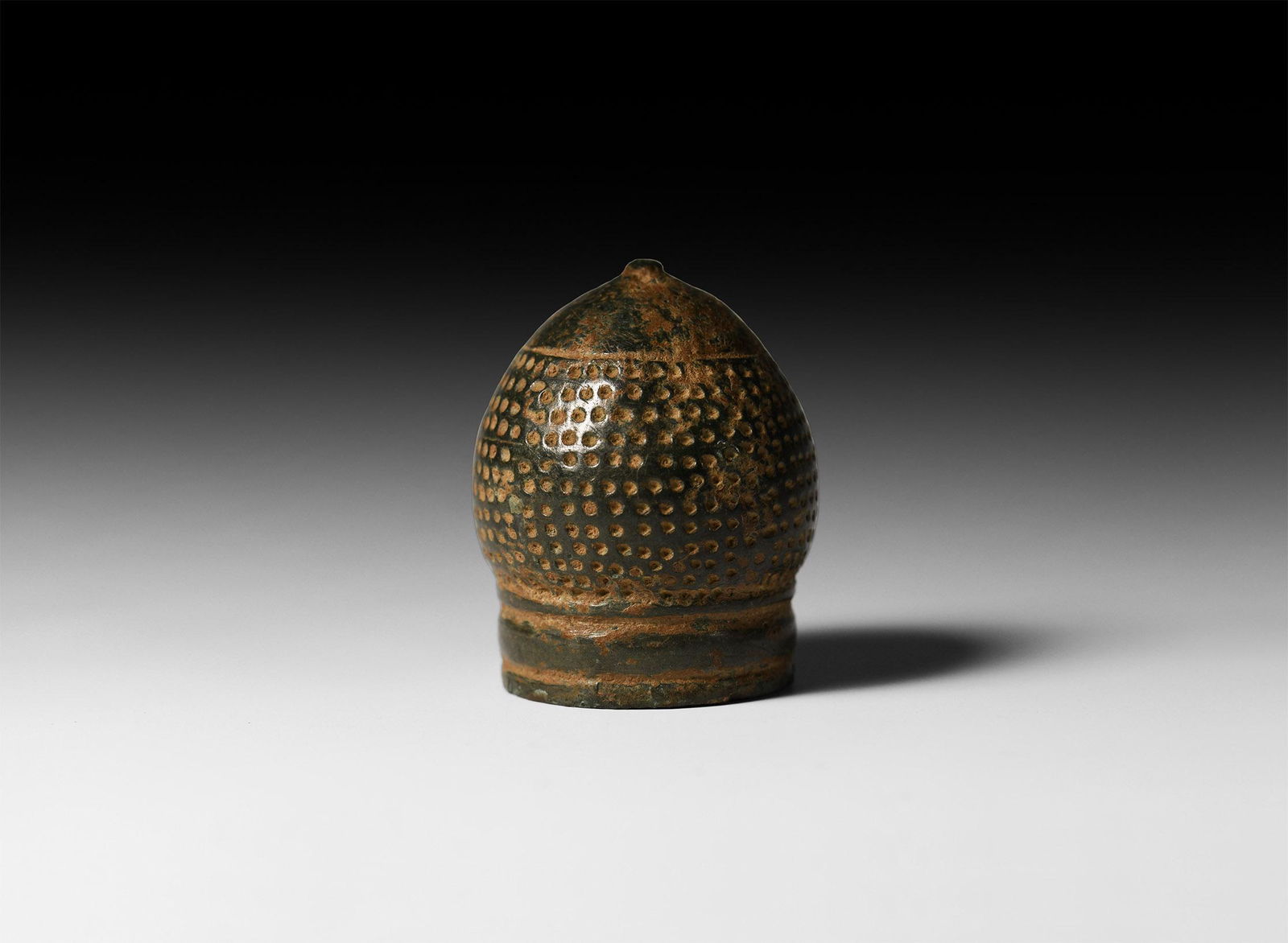 Ottoman Onion-Top Thimble: 12th-15th century AD. A substantial bronze onion-top thimble with narrow ribbed collar and knop finial, hand-punched indents to the body. Cf. McConnel, B., A Collector's Guide to Thimbles, London, 199