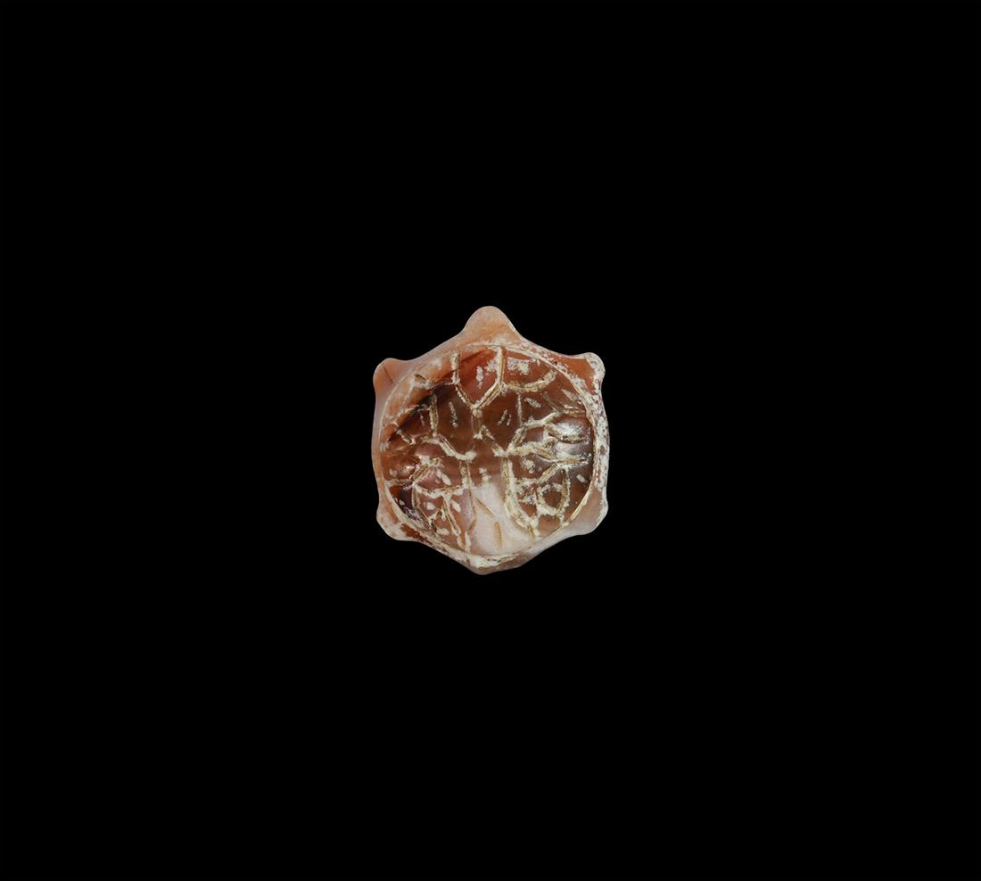 Islamic Tortoise Amulet: 12th-13th century AD. A carved banded carnelian amulet in the shape of a tortoise with segmented shell. 2.57 grams, 18mm (3/4"). Property of a Bristol collector; formerly part of his father's collecti