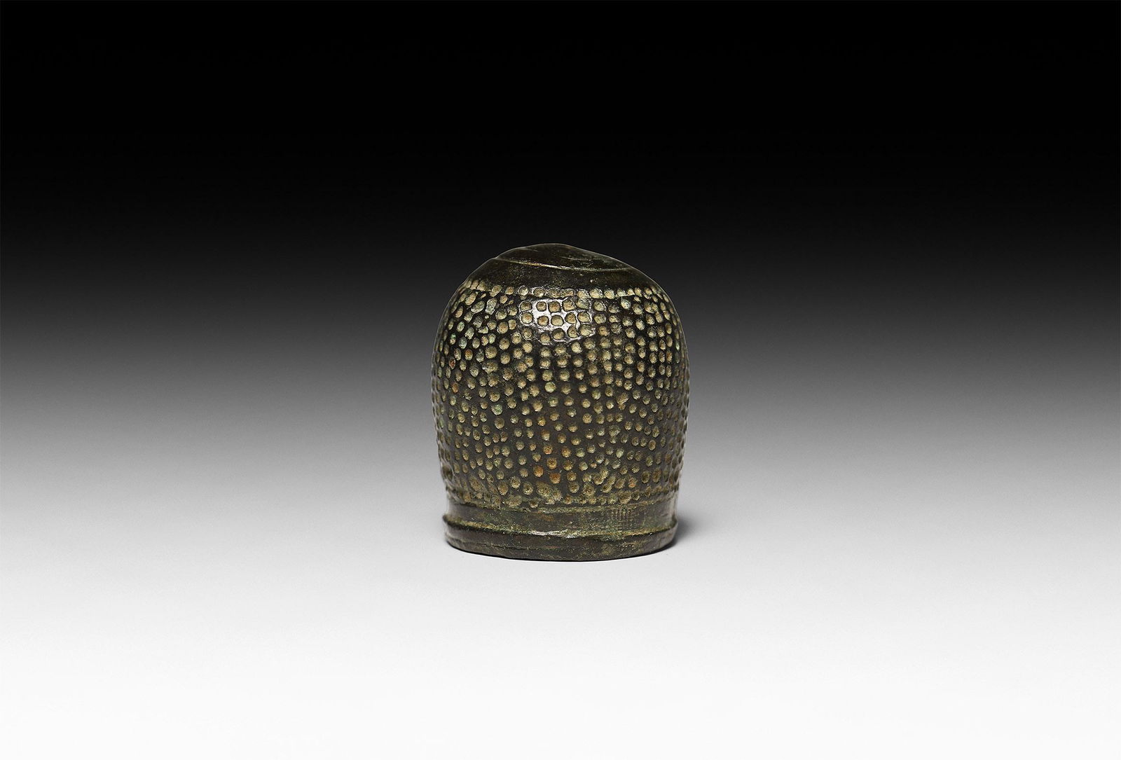 Ottoman Onion-Top Thimble: 12th-15th century AD. A substantial bronze onion-top thimble with ribbed collar and concentric circles to the top, the body with hand-punched indents. Cf. McConnel, B., A Collector's Guide to Thimbles
