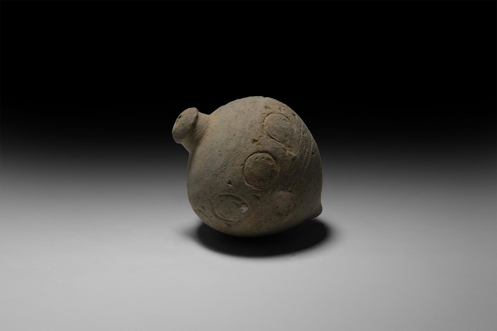 Byzantine 'Greek Fire' Fire Bomb or Hand Grenade: 9th-11th century AD. A ceramic bulbous vessel with domed top and flat base, intended to be filled with explosive liquid and wick, used as a hand grenade; a circumferential band of annulets to the shou