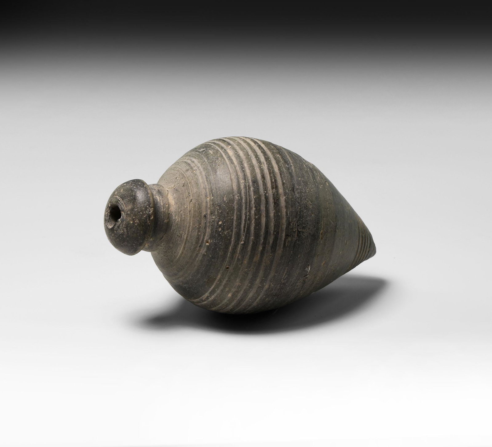 Byzantine 'Greek Fire' Hand Grenade or Fire Bomb: 9th-11th century AD. A piriform ceramic vessel with conical foot, narrow neck with domed cap, circumferential rings to the shoulder and body. Cf. Arendt, W. Irene Granaten des 13-14. Jahrhunderts, die