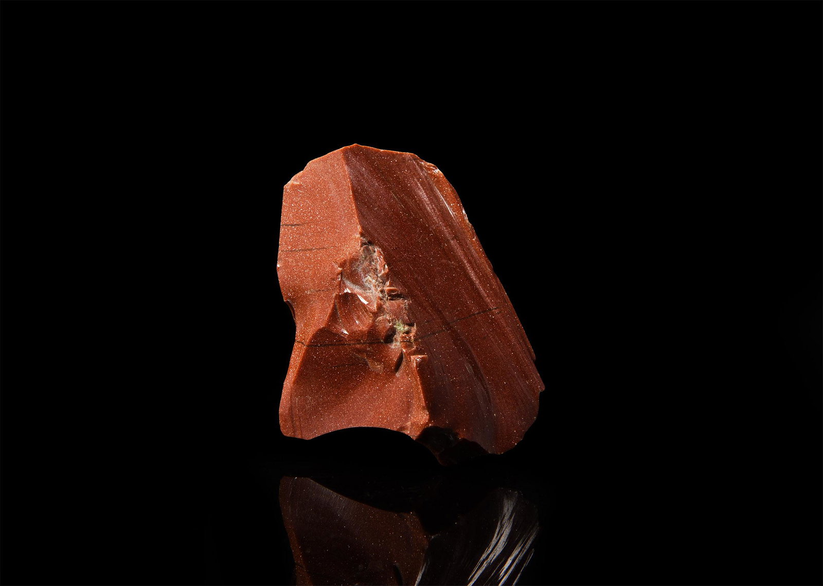 Large Goldstone Specimen: A rough cut specimen of red-brown goldstone with a bright metallic lustre. 275 grams, 87mm (3 1/2"). From the historic ‘Victorian Museum’ or later collection of Gregory, Bottley & Lloyd (Gregory's