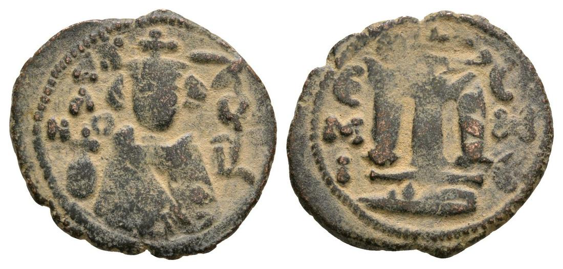 Arab-Byzantine - Facing Bust Fals: 7th-9th century AD. Hims/Homs mint. Obv: facing bust with inscription. Rev: large M with E / M / I left and C / H / C right; mintmark in exergue. See Wilkes 1, 133; cf. Foss, nos. 64-77. 2.93 grams. (