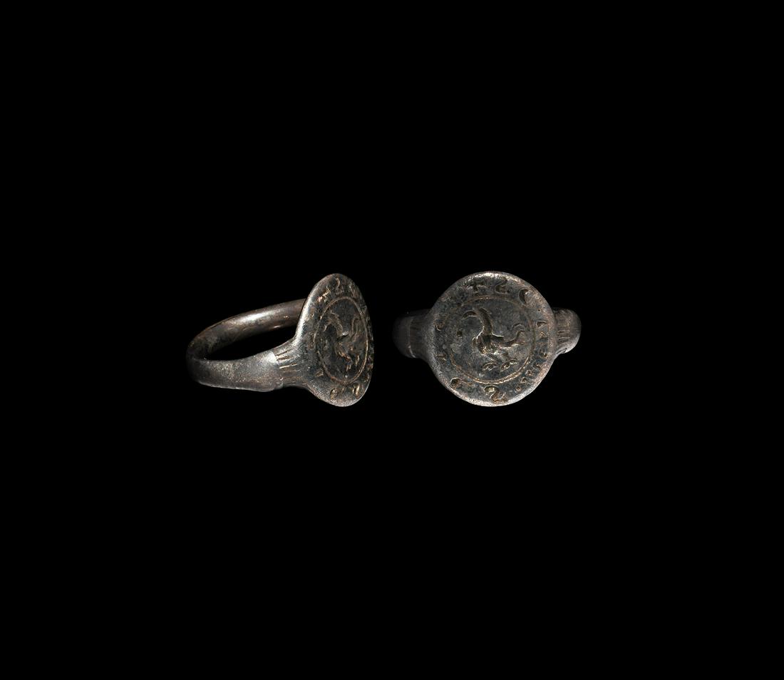 Medieval Silver Seal Ring with Cockerel, Star and: 13th-15th century AD. A silver seal ring comprising a D-section hoop expanding at the shoulders and enclosing a flat discoid bezel; a collar of decorative incised lines between shoulder and bezel; cen
