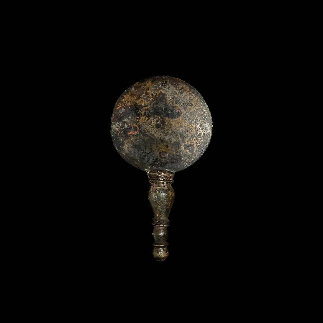 Roman Silvered Child's Mirror: 1st-2nd century AD. A small bronze silvered mirror with handle and knop finial, bulbous shaft, double flat rim, the reflective inlaid disc with polished tinned surface. See Ingo G., Plescia, P., Angel