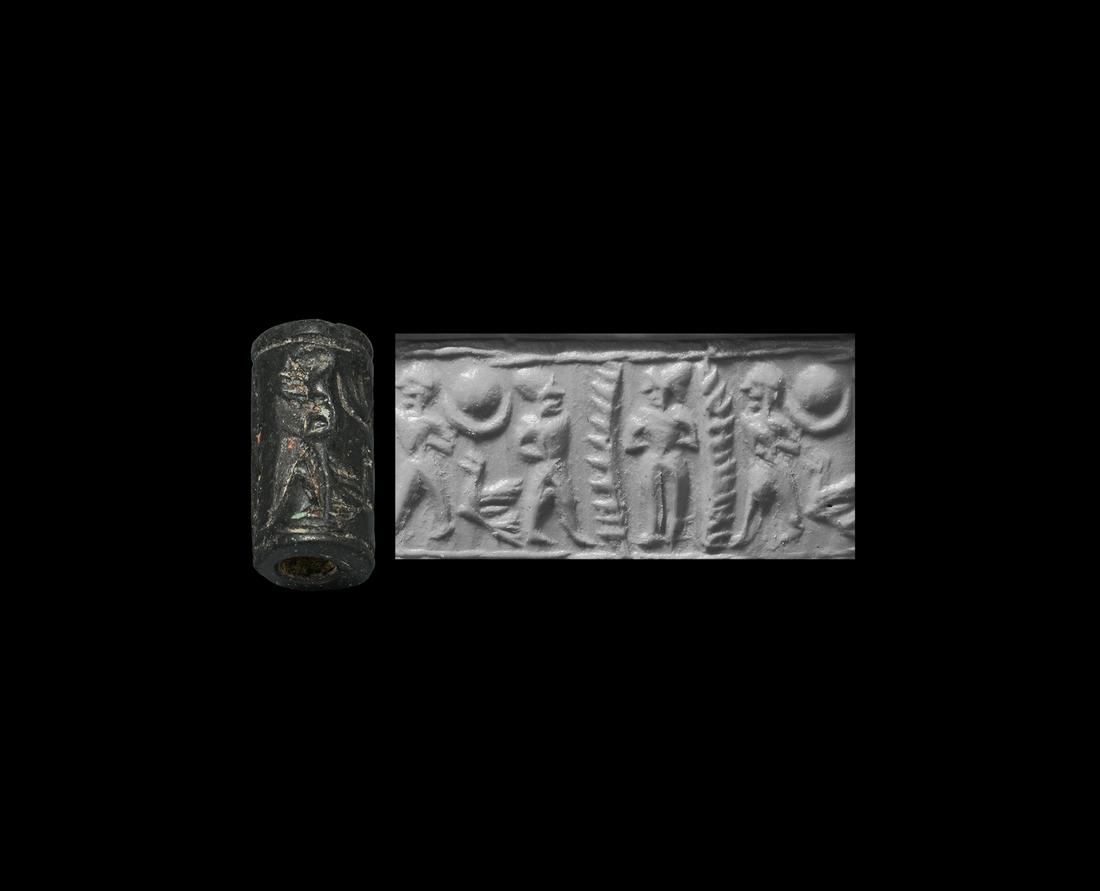 Cylinder Seal with Nude Goddess: 13th-10th century BC. A black limestone cylinder seal, drilled vertically for suspension; accompanied by a museum-quality impression and a typed and signed scholarly note issued by the late W.G. Lambe