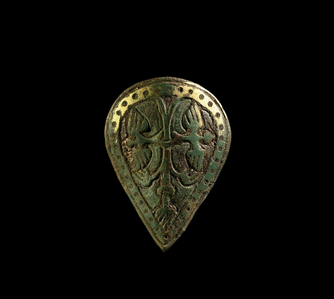 Medieval Gilt Heraldic Mount: 13th-14th century AD. A gilt bronze teardrop-shaped shield mount with border of pellets framing two birds flying away from a stem or tree-trunk with collar and forked root. 24.4 grams, 63mm (2 1/2"). 