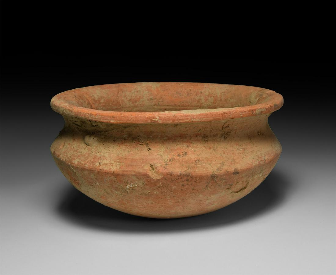 Assyrian Terracotta Bowl: 2nd millennium BC. A squat terracotta bowl with carinated body and rounded base, everted rim with lip. 650 grams, 18cm wide (7"). Ex Japanese private collection, formed 1970-2010. [No Reserve]