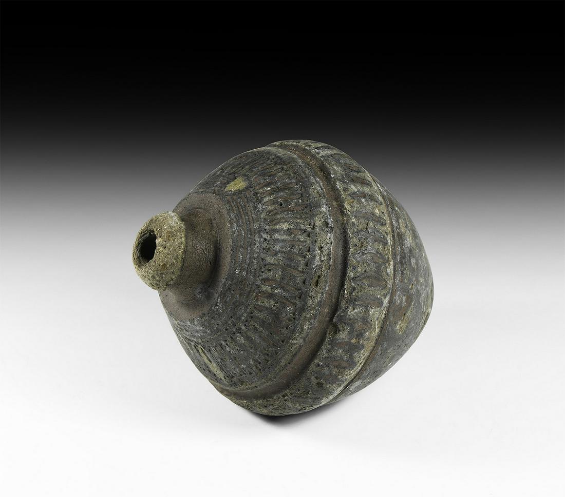 Byzantine 'Greek Fire' Fire Bomb or Hand Grenade: 9th-11th century AD. A substantial hollow ceramic vessel, biconical in shape, intended to be filled with explosive liquid and a wick, and used as a hand grenade; concentric bands and friezes of horizo