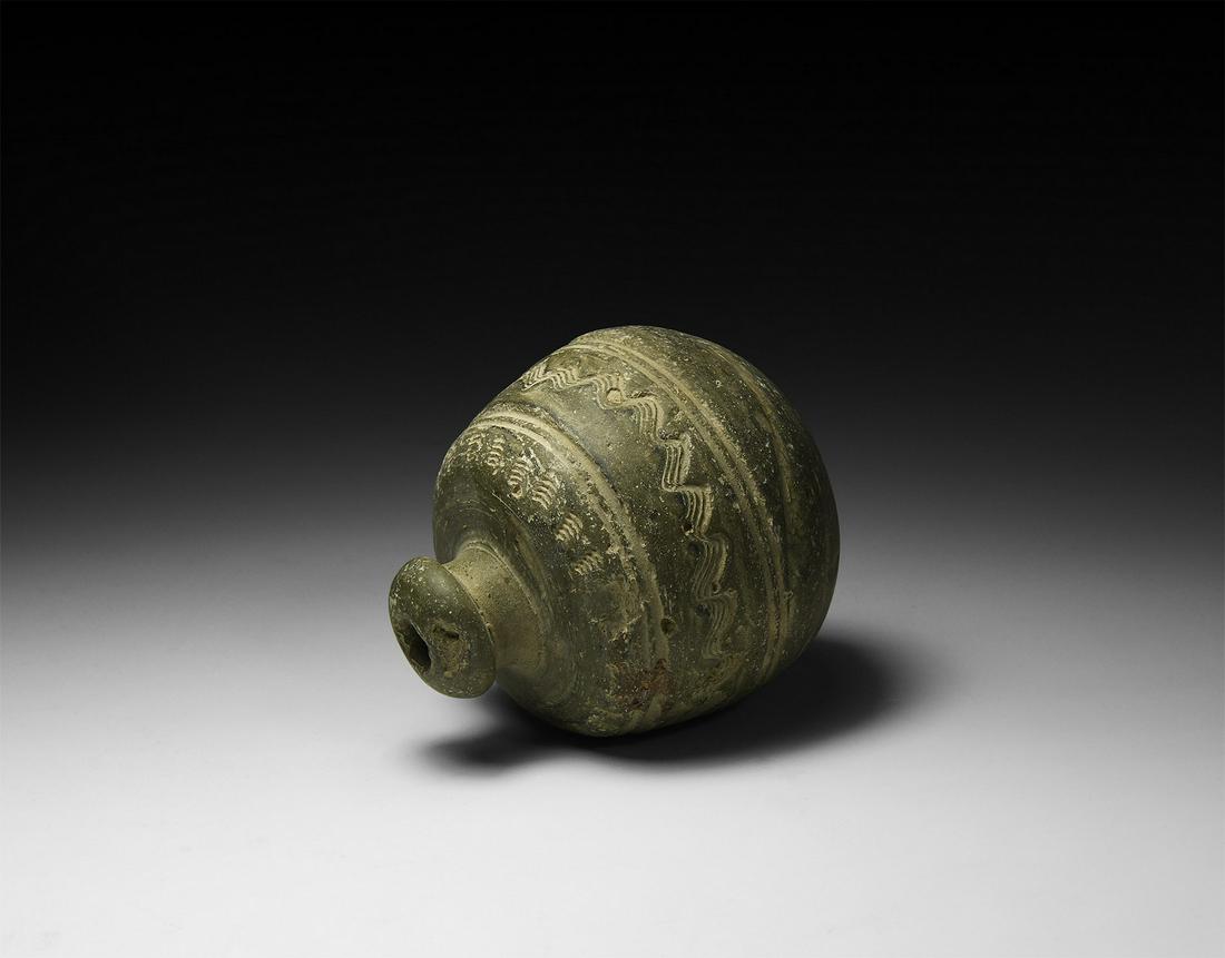 Byzantine 'Greek Fire' Fire Bomb or Hand Grenade: 9th-11th century AD. A carinated ceramic vessel with short neck, domed lip and conical base, decorated with a series of 'comb-tooth' columns at the shoulder and parallel bands below framing a circumfe