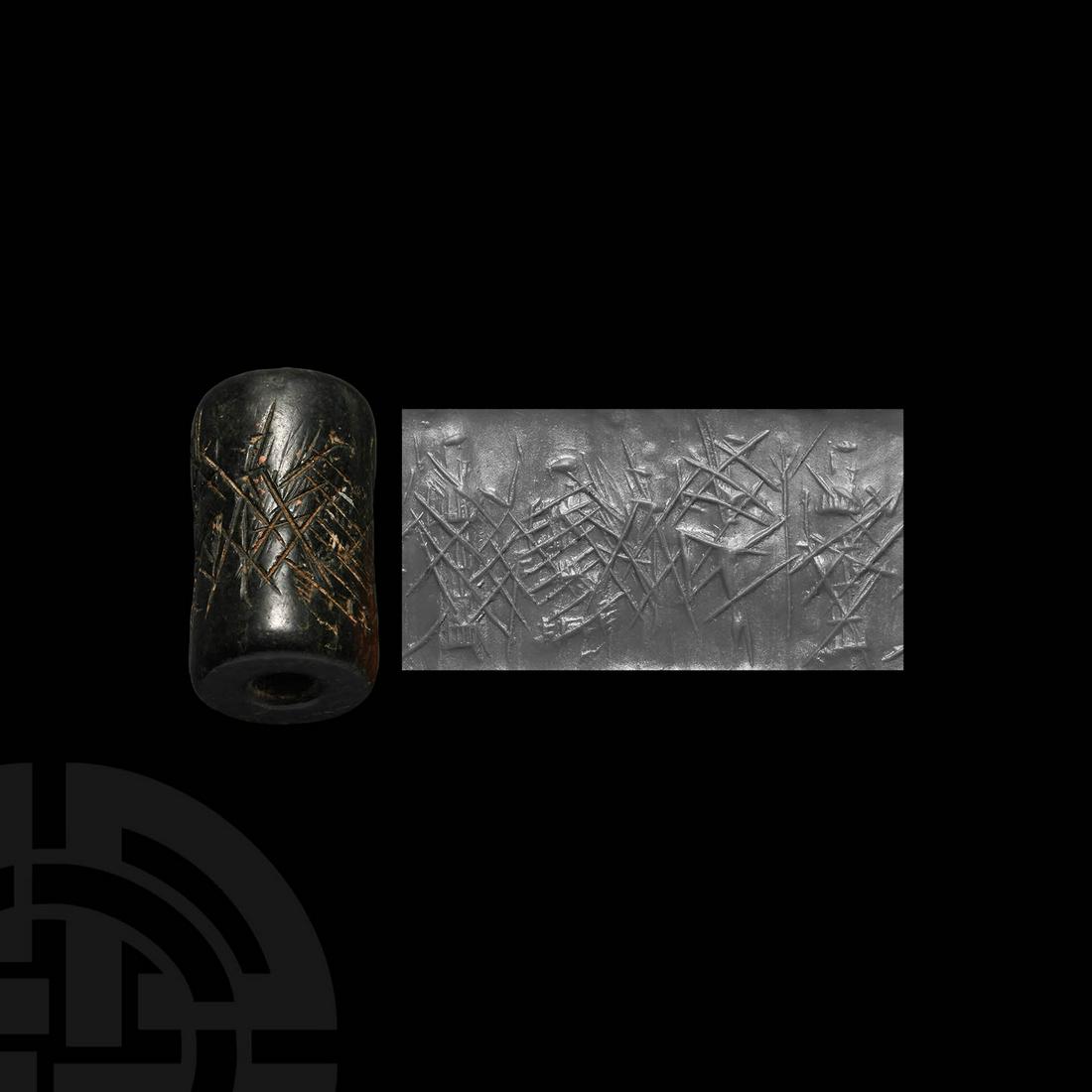 Old Babylonian Cancelled Cylinder Seal: 2nd millennium BC. A black limestone cylinder seal with figures obscured by striated lines used to deface the seal, presumably for reuse by another individual, pierced for suspension; accompanied by a