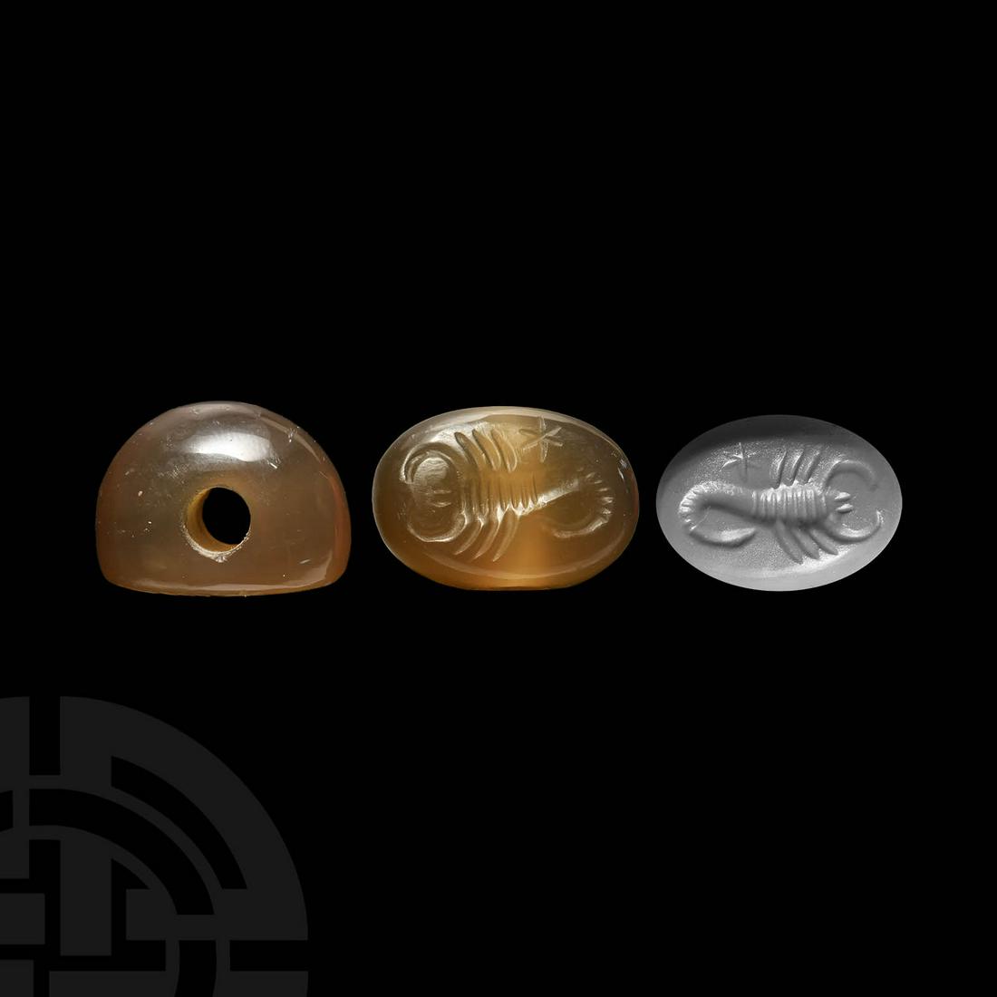 Sassanian Stamp Seal with Scorpion and Star: 3rd-7th century AD. A plano-convex agate stamp seal bearing intaglio motif of a scorpion and star to base, pierced for suspension. 5.6 grams, 20mm (3/4"). Property of a London gentleman; acquired in t