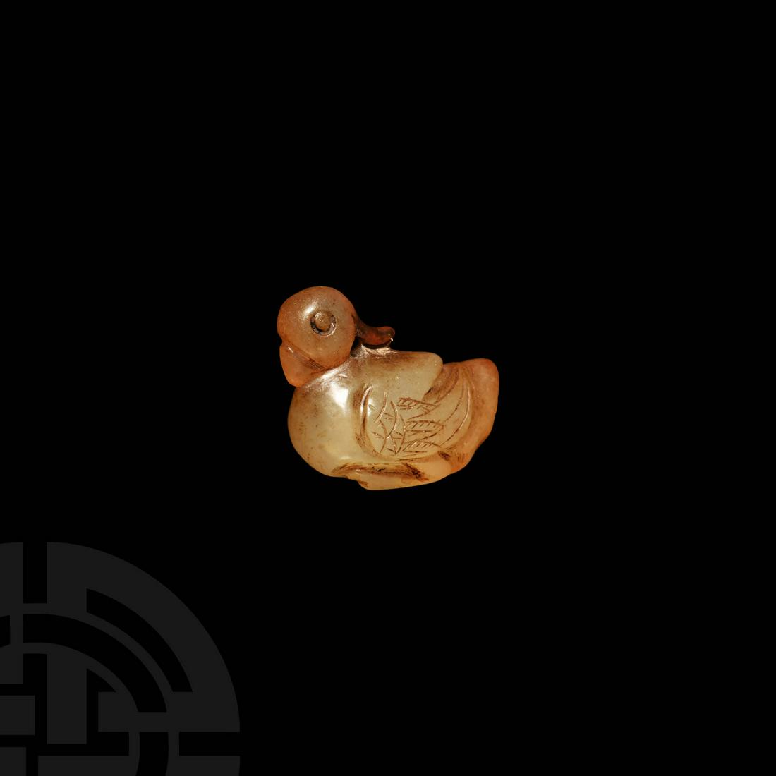 Indian Mughal Duck Amulet: 17th-18th century AD. A carved light carnelian duck modelled in the round with the head facing the tail, resting along the back, legs and feet tucked under the body, wings folded, incised detailing to