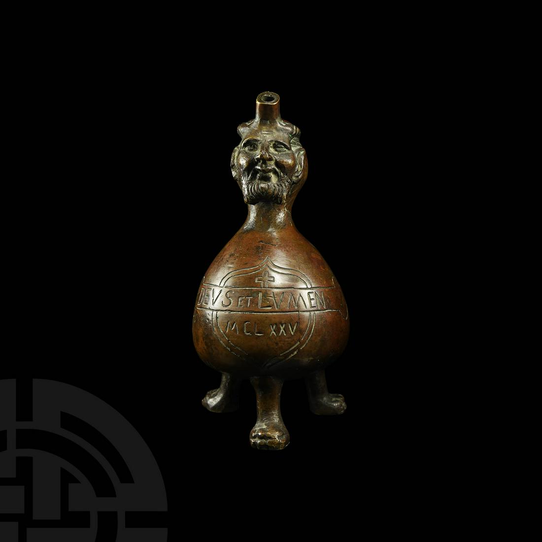 Liturgical Aquamanile: 19th-20th century AD. An aquamanile in the form of a gourd, the upper neck ornamented with a horned bestial-human hybrid mask with pointed ears and a beard, spout emerging from the forehead, hinged li