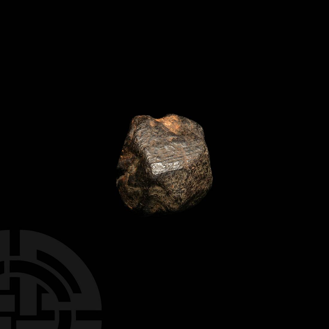 Iron Meteorite: An iron meteorite of irregular form, mostly covered by fusion crust. 68 grams, 35mm (1 1/2"). Property of a London gentleman; acquired in the 1970s. [No Reserve]