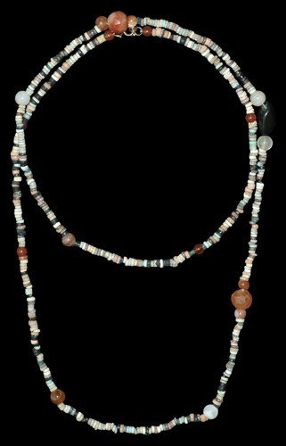 Egyptian Faience Mummy Bead Necklace: Mainly circa 664-343 BC, Late Period. A long necklace of Egyptian multicoloured faience disc beads, together with rounded and facetted carnelian and other stone beads at intervals (these possibly not