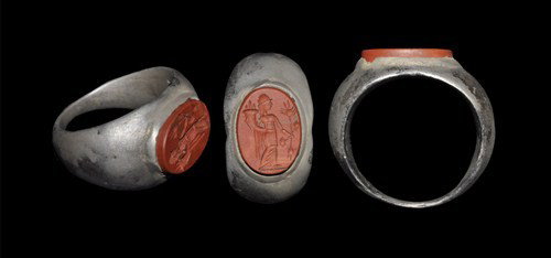 Roman Silver Intaglio Ring: 1st-4th century AD. A finger ring with expanding hoop; the bezel an elliptical intaglio bearing the image of a female in draped peplos robe with vegetation in one hand and a cornucopia in the other. S