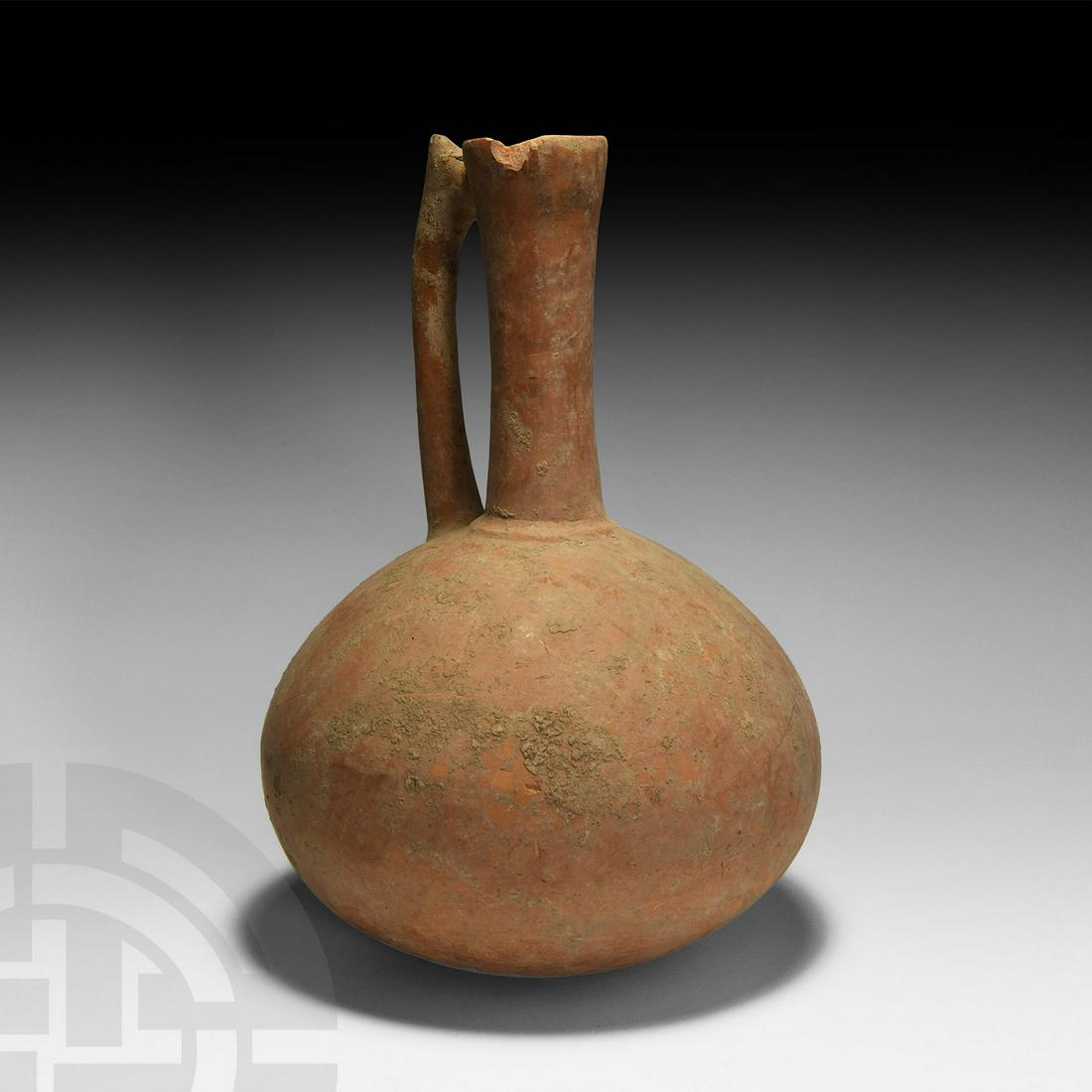 Amlash Wine Jug: 1st millennium BC. A terracotta vessel with globular body, tubular neck and single zoomorphic handle. 1.2 kg, 28.5cm (11 1/4"). Collected in the 1990s. Collection of a deceased Japanese gentleman (197