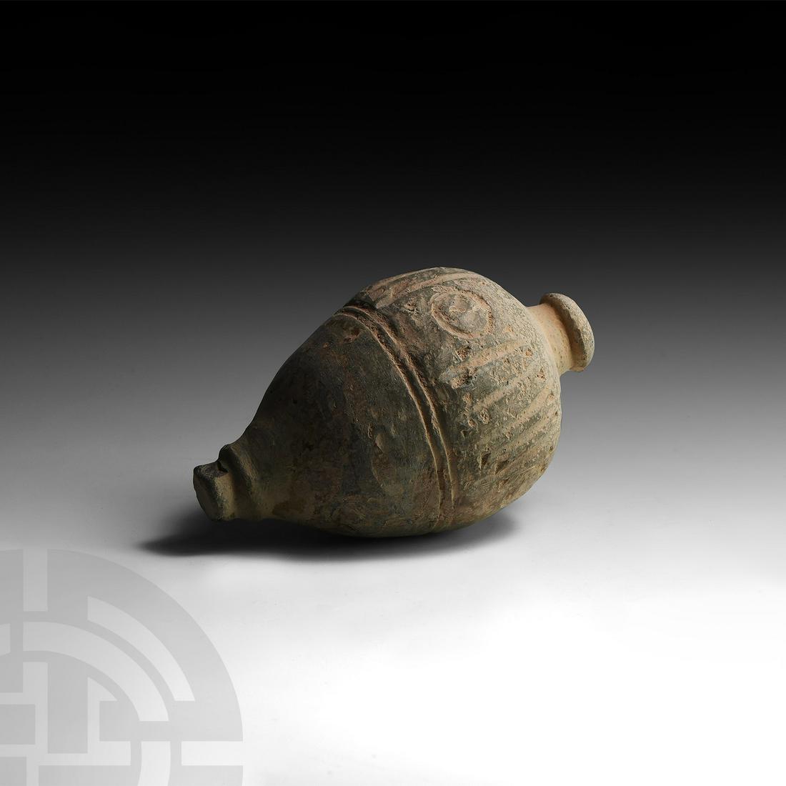 Byzantine 'Greek Fire' Fire Bomb or Hand Grenade: 9th-11th century AD. A hollow ceramic vessel with piriform body, short neck and domed mouth, decorated with a circumferential band of geometric motifs with plain bands below; intended to be filled wit
