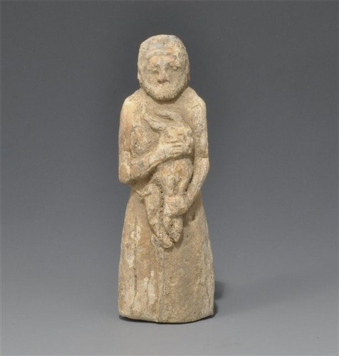 Old Syrian - Bone Goat Sacrifice Figure: Circa 1,800-1,500 BC. A carved bone figure of a bearded man in a loose robe, tied at the waist, carrying a kid or lamb by the legs and head. Bone, 20 grams total, 21-40 mm. Ex Filk collection, formed 