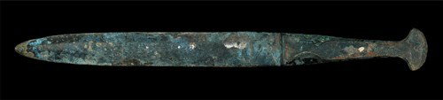 Bronze Age - Flange-Hilted Dagger: Circa 12th century BC. A cast bronze dagger of Type III with parallel-sided double-edged blade of lenticular section; the hilt formed as a raised panel with lateral flanges to be folded onto an organi