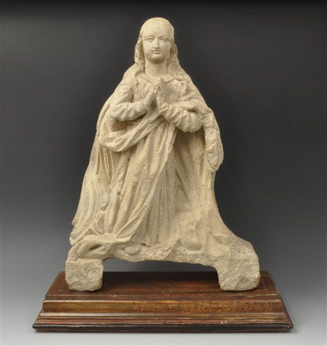 Medieval - Limestone Virgin Mary Figure: Circa 16th century AD. A carved limestone figure of the 'virgo immaculata', modelled in the half-round; the head partly covered, with flowing hair and rounded features; the robes loose and the mantle
