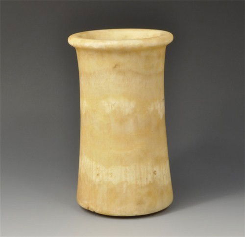 Near Eastern - Bactrian Alabaster Vessel: Circa late 3rd-early 2nd millennium BC. Cylindrical in form, flaring to the slightly rounded base, with an overhanging rounded disc rim. Alabaster, 2.5 kg, 21.3 cm high. See Christies sale 1846, lot 5