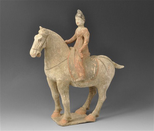 Chinese - Early Tang Horse and Court Lady Rider: Circa 618-906 AD Tang Dynasty. A horse set four-square upon an integral rectangular base supporting a saddled female rider; the horse having a prominent curving neck with hogged mane; tall pointy ears