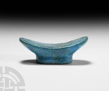 Egyptian Blue Glazed Model of a Headrest: New Kingdom, 1550-1070 B.C. A bright blue glazed composition miniature headrest with scooped pad and ellipsoid foot. See Friedman, F.D., Gifts of The Nile, Ancient Egyptian Faience, London, 1998, p.32