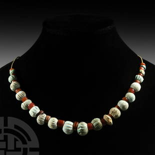 Romano-Egyptian Faience Bead Collection: 1st century B.C.-4th century A.D. A restrung necklace composed mainly of composition melon beads and carnelian beads; modern clasp. 40 grams, 42 cm (16 1/2 in.) Acquired on the UK art market in the