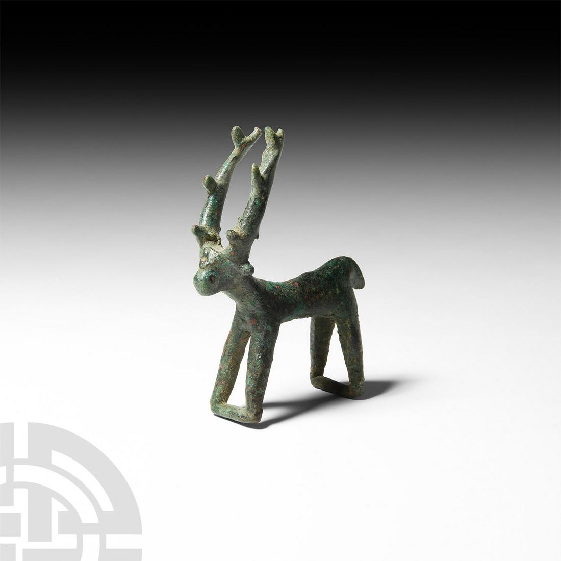 Luristan Stag Figurine: 13th-6th century B.C. A bronze figure modelled as a stylised standing stag with bars between the feet, notches to the tall antlers, short tail. 102 grams, 86 mm wide (3 3/8 in.) UK private collection 