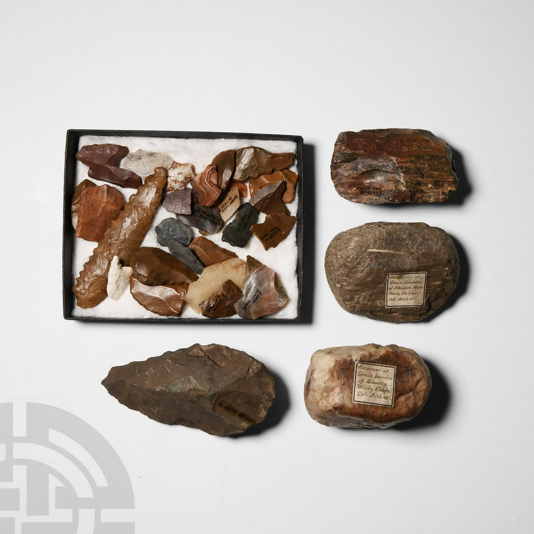 Stone Age Handaxe and Other Artefact Group: Palaeolithic Period, 150,000-7000 B.P. and later. Group comprising: small stone bifacial handaxe, from Sahara region; arrowheads and other chert implements, some with wind polish, most with inked 'Wad