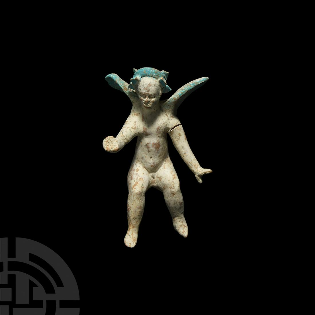 Grand Tour Polychrome Eros Terracotta Figurine: 18th-19th century A.D. A ceramic Tanagra style figure of Eros seated and with arms outspread, headdress in hair and wings outspread; headdress and wings in blue pigment, white slip over body. 105 gram