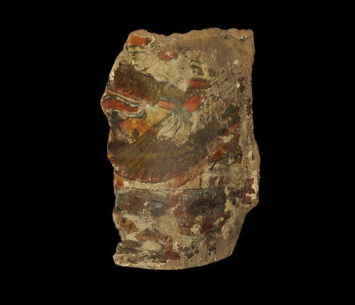 Egyptian Cartonnage Coffin Fragment: Late Period, Ptolemaic, 305-30 BC. A foot portion of a coffin with a complex curve to one end, painted with symbolic motifs including the wedjat eye and stylized wings in red, blue and black on a yell