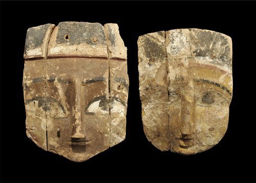 Egyptian Wooden Polychrome Mask Group: Late Dynastic Period, circa 664-332 BC. A group of two polychrome wooden masks with carved facial details and headdress; pegged construction. Wood, 1.2 kg, 30-34 cm. Ex Malcom Hay collection. [2]