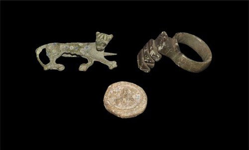 Roman Artefact Group: Circa 1st-3rd century AD. A mixed group of artefacts comprising: a cast bronze finger ring with key to the bezel; a lead weight with phallus motif; a reclining panther plate brooch with enamel roundel