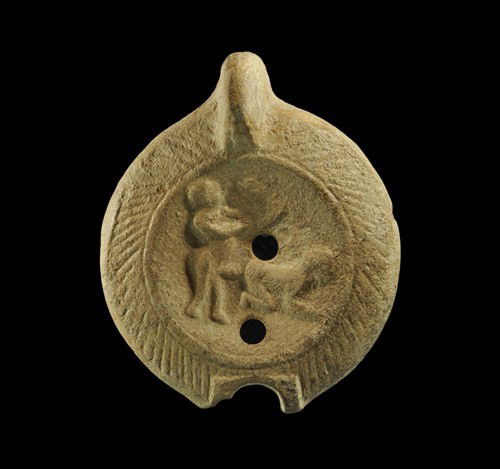 Roman Ceramic Erotic Lamp Fragment: Circa 1st-3rd century AD. A fragment of a ceramic oil lamp with fin handle and hatched border; the discus depicting a scene of sexual penetration. Ceramic, 70 grams, 10 cm. Ex Barker collection, forme