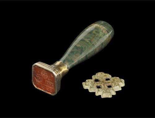 Medieval Knights of the Holy Sepulchre Cross Group: Circa 15th century-19th century AD. A medieval Knights of the Holy Sepulchre repoussé pilgrim badge of cross crosslet form; and a Georgian carnelian seal mounted in a silver block with polished stone