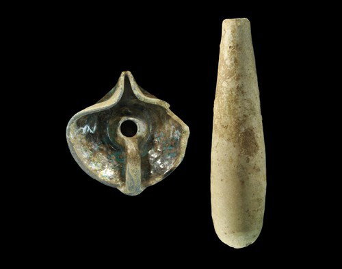 Islamic Medieval Ceramic Vessel and Lamp Group: Abassid Period, 8th-10th century AD. A group of two ceramic vessels comprising: a tubular creamware phial in iridescent glaze with rounded base; a discoid ceramic lamp with thick basal ring, central r