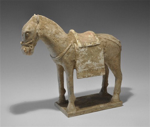 Chinese Ceramic Ming Dynasty Caparisoned Pony: Ming Dynasty, 1368-1644 AD. A ceramic model of a caparisoned pony on a rectangular base; the facial details, tail, mane and bridle carefully modelled; the saddle, collar and crupper depicted and the f