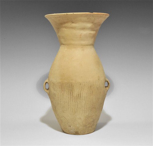 Chinese Neolithic Creamware Jar: Circa 3rd millennium BC. A tall biconical creamware jar with two small lug handles and wide funicular neck; vertical texturing to the lower body. Ceramic, 1.2 kg, 28 cm. Property of a London Gentleman