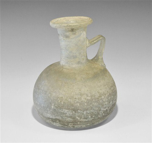 Roman Style Glass Flask: A very large undated translucent blue glass flask with bulbous body, tall neck, everted rim, strap handle and broad base. Glass, 850 grams, 20 cm. Ex Roger Warner collection. [No Reserve]