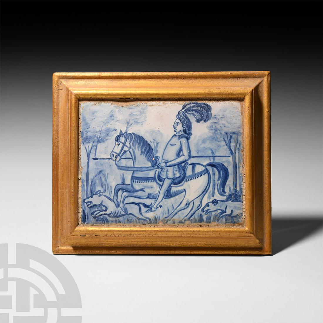 Spanish Blue and White Tile with Hunting Scene: Possibly 18th century A.D. A blue and white rectangular tile depicting a hunting scene set in woodland, showing a mounted rider galloping left, holding a spear and wearing a plumed headdress, hunting 