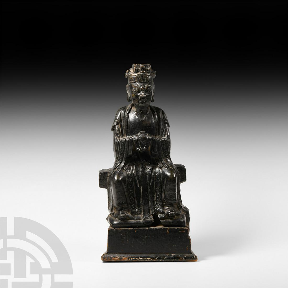 Chinese Ming Seated Magistrate Figurine: Ming Dynasty, 16th-17th century A.D. A bronze figure of a seated magistrate, holding a sceptre, wearing a robe with details of lotus scrolls to the hem; cap inscribed 'Wang Ping Jiang', the reverse in