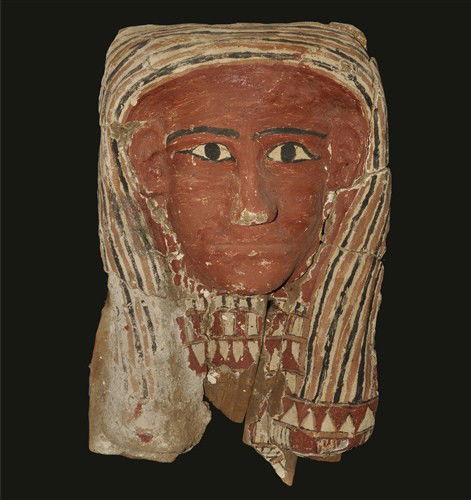 Egyptian Mummy Cartonage Face Mask: 26th Dynasty, circa 685-525 BC A human face moulded in plaster over a wooden former, painted in red on a cream base with ochre and black detailing; supplied with custom-made frame. Wood and plaster, 6