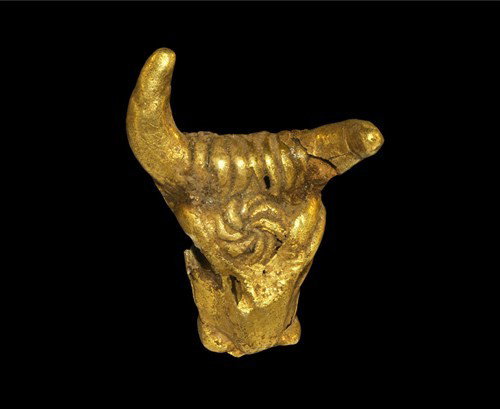 Near Eastern Syrian Gold Bull's Head Pendant: Circa 1st millennium BC A hollow sheet gold model of the head of the sacred bull with crescent horns, elliptical eyes and broad muzzle, and the radiating solar symbol on its forehead. Gold, 1.17 grams