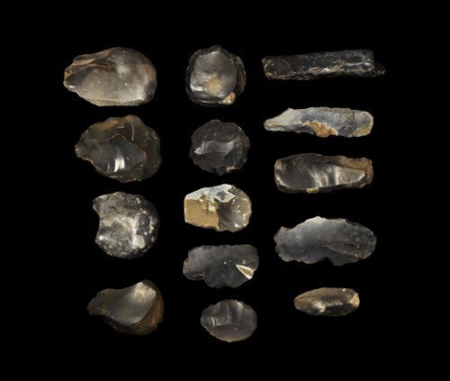 Stone Age Group of Neolithic Flint Implements: Circa 5,000-3,000 BC Group of knapped flint implements, including eight large convex-edged scrapers, five blade based scrapers or knives and one slender part polished axe (large fragment"). See Evans,
